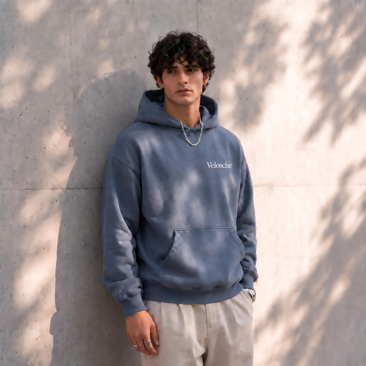 Man wearing a Velosche hoodie, brand lifestyle image